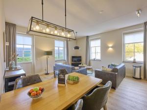 a dining room and living room with a table and chairs at Sauna Zee 27A in Colijnsplaat