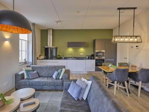 a living room with a couch and a table at Sauna Zee 27A in Colijnsplaat