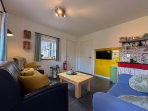 a living room with a couch and a table at Op de Beemd in Zeeland +39 photos