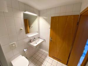 a bathroom with a toilet and a sink and a shower at Panoramablick-Orther-Hafen-Fehmarn in Orth +19 photos