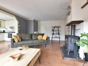 a living room with a couch and a wood stove at t Kaatsheuveltje 2 in Kaatsheuvel