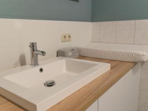 a white sink in a bathroom with a tub at Alpacafarm Vorstenbosch in Vorstenbosch +38 photos