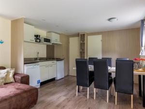 ein Wohnzimmer mit Tisch, Stühlen und Sofa in der Unterkunft Easy Chalet in Vessem