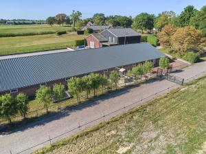 an overhead view of a barn with a fence at De Rouwenbogt in Reusel