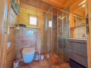 a bathroom with a toilet and a glass shower at Onder de oude Eik in Lottum +24 photos