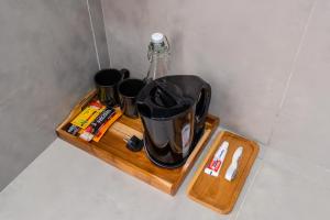 a wooden shelf with a tea pot and cups on it at Gumitish Residence Singaraja in Singaraja