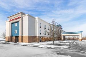 a building with a sign on the side of it at Hampton Inn & Suites New Castle, PA in New Castle