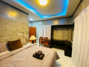 a bedroom with a bed with a teddy bear on it at Thawat Villa Boutique Resort in Ko Lanta +82 photos