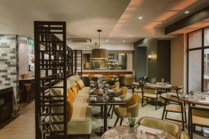 a restaurant with tables and chairs and a ladder at Doubletree By Hilton Wellington in Wellington
