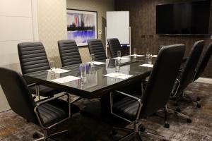 a conference room with a glass table and chairs at Doubletree By Hilton Wellington in Wellington