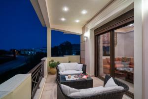 a balcony with two chairs and a table at Athena's Holiday Home - Ideal for large groups, by ZanteWize in Tsilivi