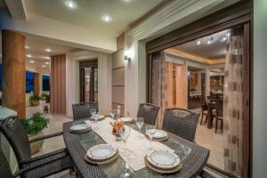 a dining room with a table and chairs at Athena's Holiday Home - Ideal for large groups, by ZanteWize in Tsilivi +34 photos