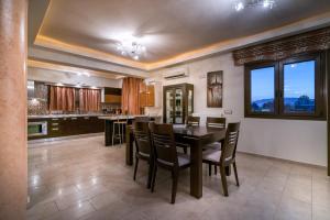 a kitchen and dining room with a table and chairs at Athena's Holiday Home in Tsilivi