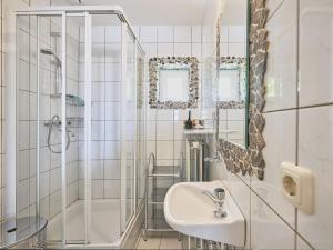 a white bathroom with a shower and a sink at Rose Garden in Stevensweert +92 photos