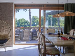 a dining room with a wooden table and chairs at Silt in Schinnen
