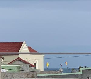 a group of kites flying in the sky over the ocean at Du mục stay in Ninh Hải