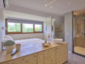 a bathroom with a large bed and a glass shower at Silt in Schinnen +40 photos