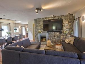 a living room with a couch and a stone fireplace at Pure Rust in Holten