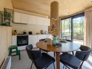 a kitchen and dining room with a table and chairs at Mos in Nunspeet +40 photos