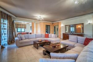 a large living room with couches and a table at Athena's Holiday Home in Tsilivi