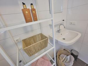 a small white bathroom with a sink and a mirror at De Linde in Nunspeet +43 photos
