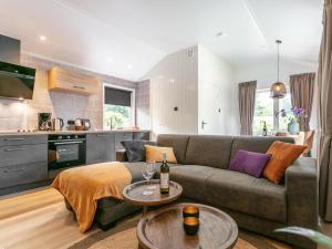 a living room with a couch and two tables at De Fazant in Hulshorst