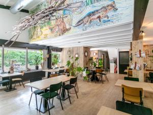 a restaurant with tables and chairs and a mural at Mos in Nunspeet