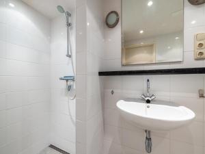 a white bathroom with a sink and a shower at Kieft in Boornzwaag +28 photos