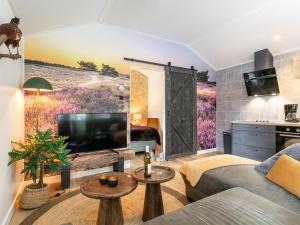 a living room with a large screen tv and a couch at De Fazant in Hulshorst