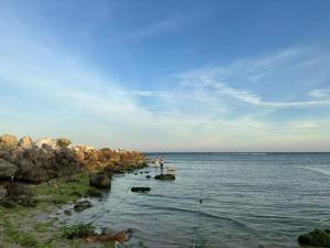 a group of people standing on rocks in the water at Du mục stay in Ninh Hải