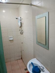 a bathroom with a sink and a shower with a mirror at Highway Inn in Mukah