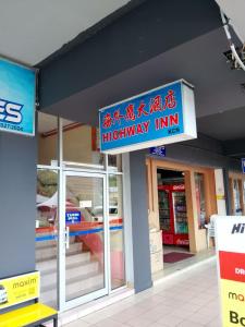 a highway inn sign on the side of a building at Highway Inn in Mukah