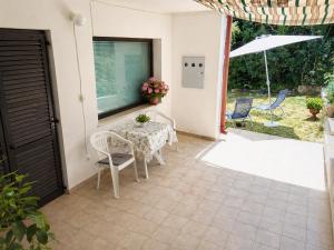 a table and chairs on the patio of a house at Ina in Funtana