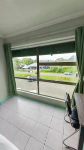 a room with a window with a view of a street at Highway Inn in Mukah
