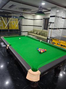 a pool table with balls on it in a room at Om Sai Ram Coliving in Bangalore