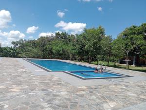a couple of people in a swimming pool at Seeing Green Udawalawa in Udawalawe +59 photos