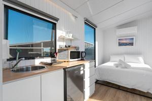 a small bedroom with a bed and a sink at Starry Night Farmstay by Tiny Away in Forbes