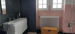 a bathroom with a sink and a radiator at Balcon des fées in Le Malzieu-Ville +19 photos