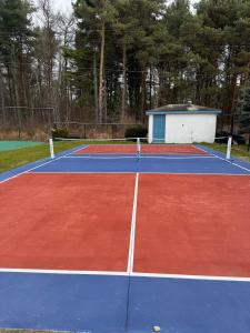 a tennis court with a net on top of it at Great Lakes Resort - Family Suite - Suite 1 in Lexington