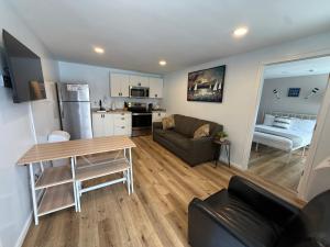 a kitchen and living room with a couch and a table at Great Lakes Resort - Family Suite - Suite 1 in Lexington