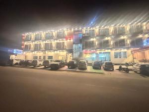 a building with cars parked in front of it at night at Trishul inn in Rudraprayāg +17 photos