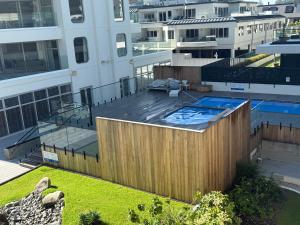 an overhead view of a swimming pool on a building at Oceanside Resort & Twin Towers in Mount Maunganui