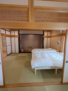 a bedroom with a bed in a room at 和の貸切宿yanagiya in Daisen +37 photos