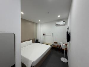 a bedroom with a white bed and a mirror at Charm House Hue in Hue