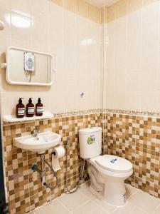 a bathroom with a toilet and a sink at Nipat home petfriendly in Ban Khlong Prawet