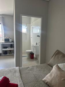 a bedroom with a bed and a bathroom with a toilet at 05 Studios centro,proximo a rodoviaria-itapeva sp in Itapeva