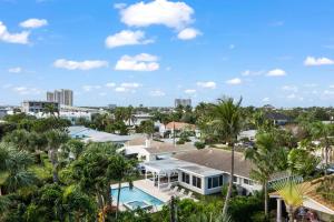 an aerial view of a resort with palm trees at The Coastal Duo Escape in West Palm Beach