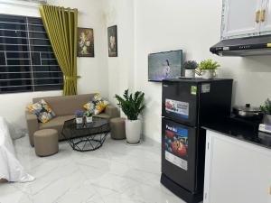 a living room with a couch and a table at Harmony Apartment in Hanoi