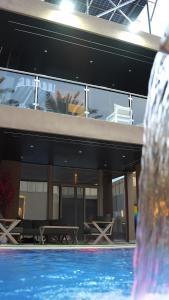 a large building with a swimming pool in front of it at Bianca Villa in Al Rama