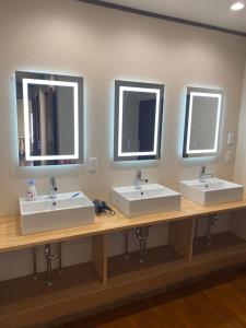 two sinks in a public bathroom with two mirrors at Guest House KURA 776 Mt Fuji View and 1 min to Gekkoji Station in Fujiyoshida +56 photos